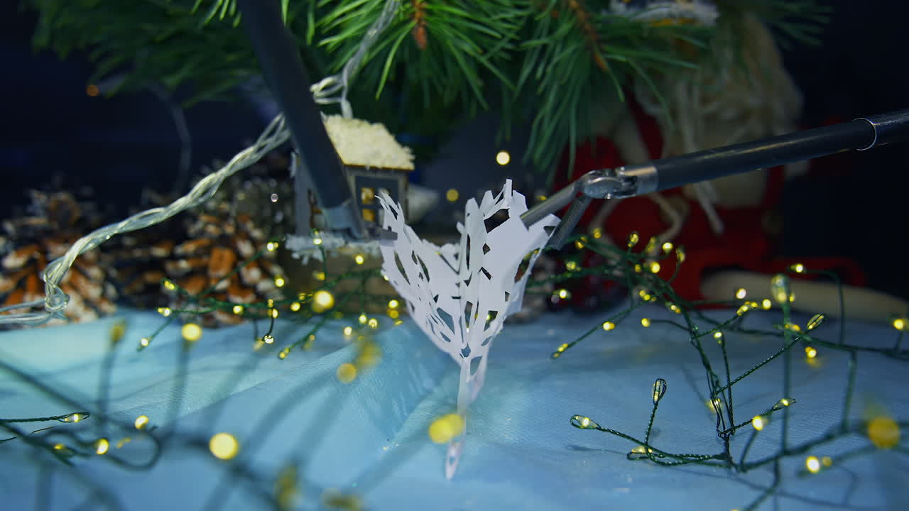 Modern robotic equipment for surgical operations unfold the paper clip. Christmas decorations with the help of innovative futuristic system. Close up.