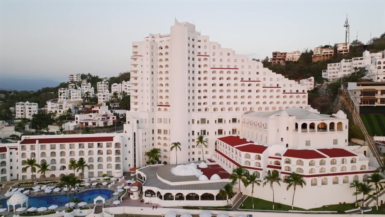 Veduta d'insieme del lussuoso Tesoro Manzanillo con design mediterraneo a terrazze. Una panoramica a sinistra rivela la spiaggia La Audiencia, Messico.