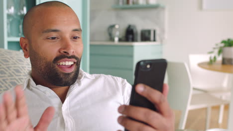 smartphone, video call and black man in living