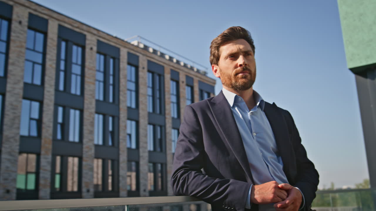 Relaxed businessman thinking life pondering at modern building balcony closeup