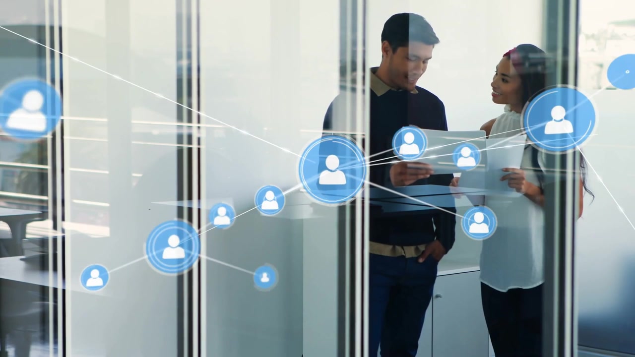 Male colleague holding tablet, female pointing papers, sparking blue network visuals for business