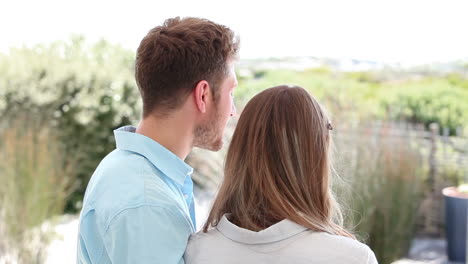 brunette haired couple looking into the distance