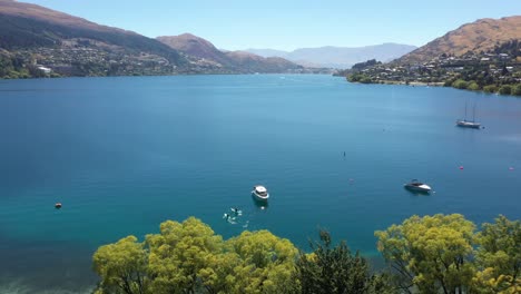 aerial uhd shot of queenstown lakes on perfect sunny day