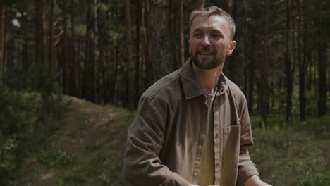 man playing frisbee in the forest
