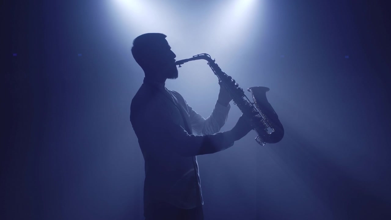 Backlit silhouette of dj man, saxophonist, singer vocalist woman standing start performance on stage