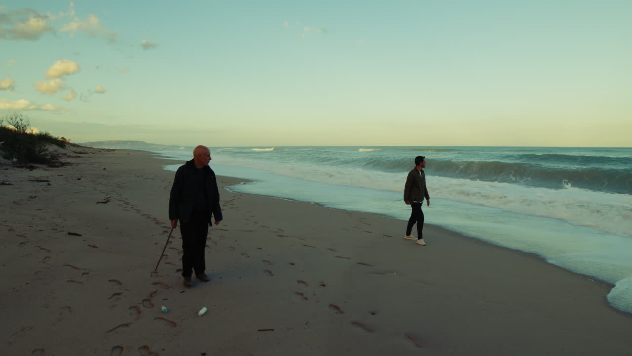 Relaxing With a Walk Near the Stormy Ocean Waves in the Morning