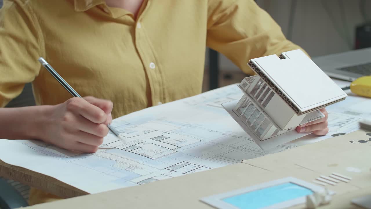 Close Up Of Hand'S Woman Engineer Holding Paper Model Of House At The Office
