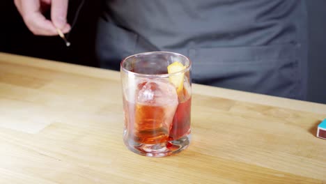 Garnishing-a-negroni-with-a-flamed-orange-zest