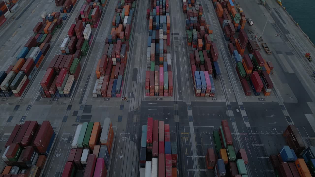 Aerial view of cargo containers stack at dusk, evening 4K