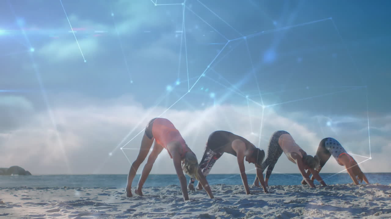 People practicing yoga on beach with digital network animation overlay