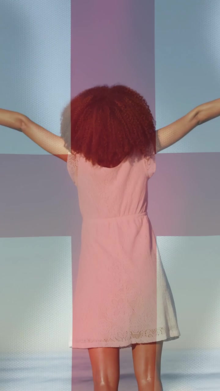 Video verticale: Donna che inizia ad alzare le braccia dai fianchi, posando con una proiezione di moda a croce sul busto.
