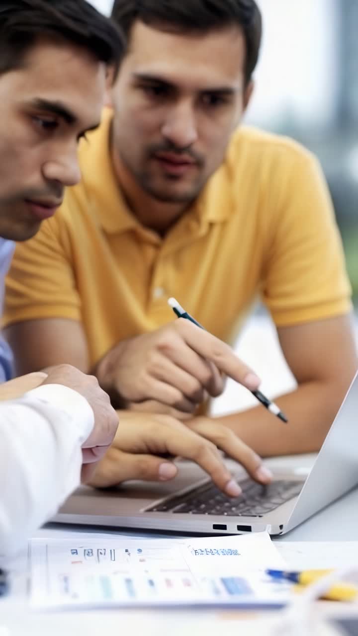 Business people are working on a laptop together in office