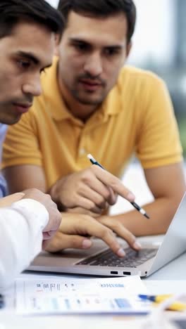 business people are working on a laptop together in office