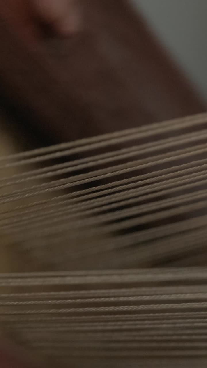 Close-up of weaving loom with threads