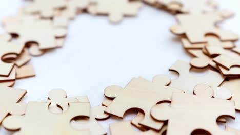 Explore the intricate world of puzzle pieces and the satisfaction of assembly in a cozy indoor setting.
