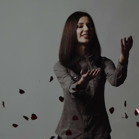 red hearts confetti, falling background of a beautiful girl. slow motion square video