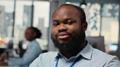 smiling portfolio manager at computer desk evaluates assets based on statistics