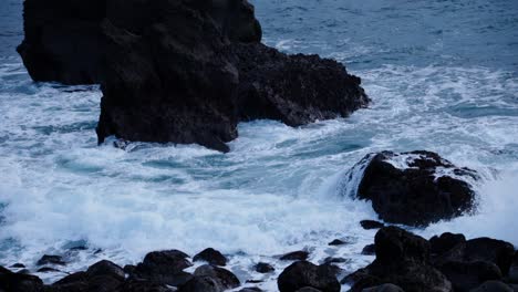 Stormy-swell-waves-crashing-on-rugged-basalt-rock-shore,-Iceland