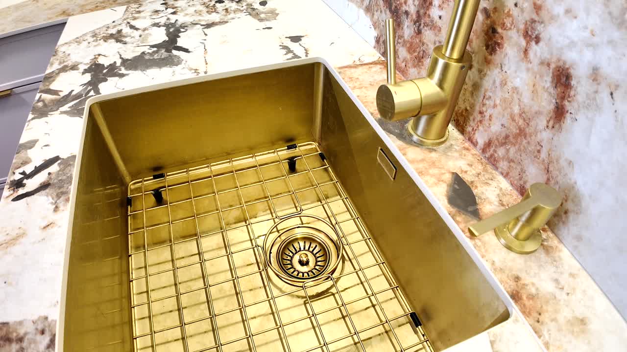 Gold Kitchen Sink with Brass Faucet and Marble Countertop