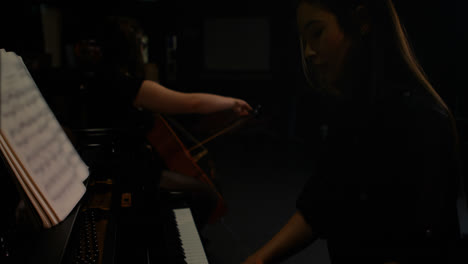 two women playing a violin and piano