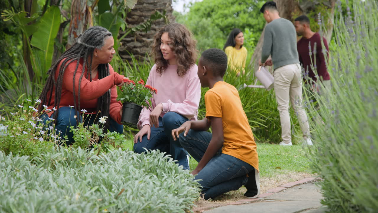 Family gardening together, sharing joyful moments and planting flowers in backyard