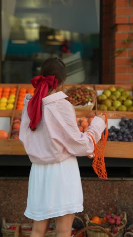 woman shopping for fruits at a grocery store