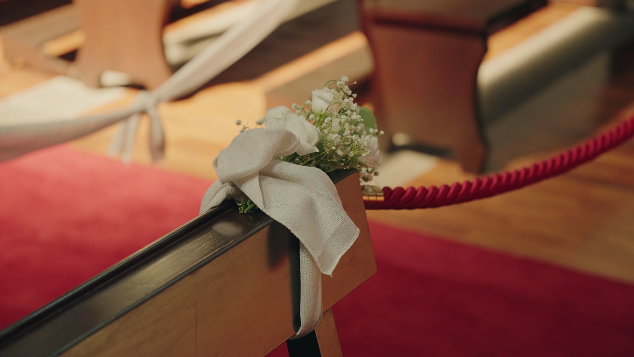 close up of church pew wedding floral decoration