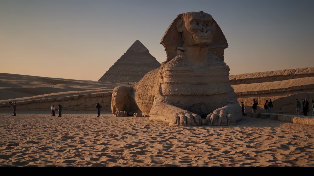 Low-angle video shot of the Sphinx and Pyramid at sunset, capturing the grandeur and mystery