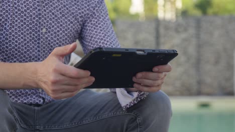 Closeup of person holding tablet with both hands, showcasing sleek modern technology