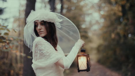woman in white dress with lantern in a mystical forest