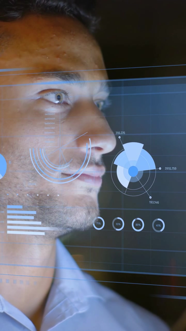 Vertical video: Man shifting gaze and starting HUD overlay in technology hub, analyzing data