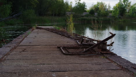 dolly in shot of a rusted railing on a pier at the prypiat river in ukraine