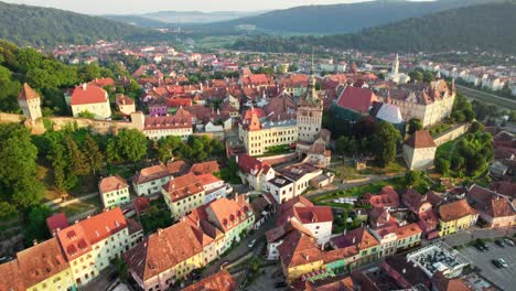 medieval city of sighisoara, transylvania, romania. aerial view of town hall and rooftops of sighisoara - one of the most beautiful cities in romania. uhd, 4k