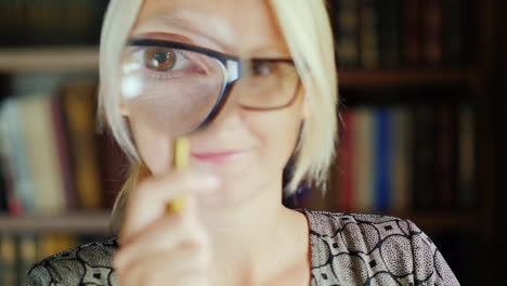 woman using magnifying glass portrait