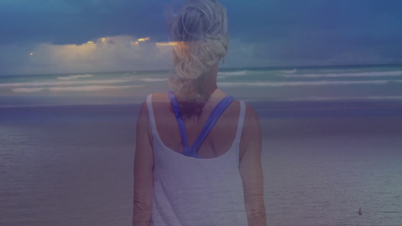 Animation einer Landschaft mit Ozean über einer kaukasischen Frau am Strand