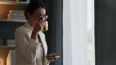 Mujer-Mirando-Por-La-Ventana-Bebiendo-Té-Y-Feliz