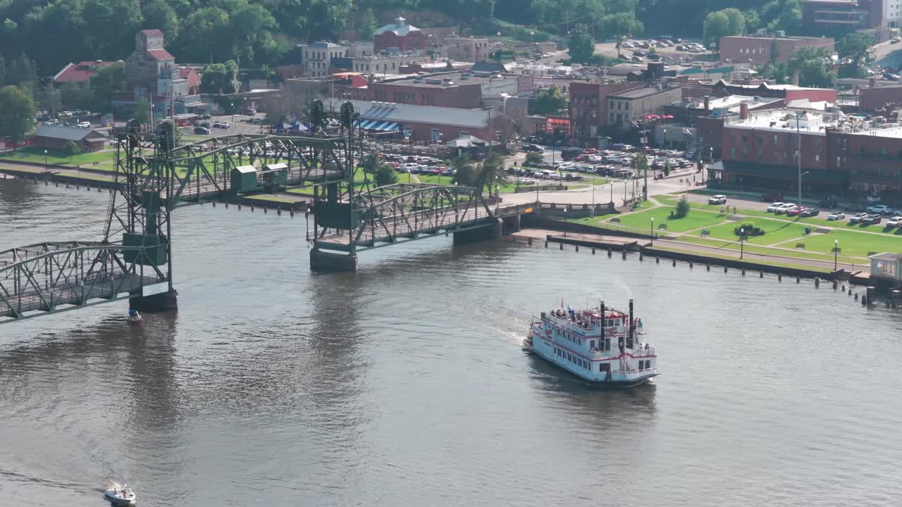 Aerial telephoto panning shot of a riverboat and the elevated lift bridge on the St. Croix River in Stillwater, Minnesota. 4K