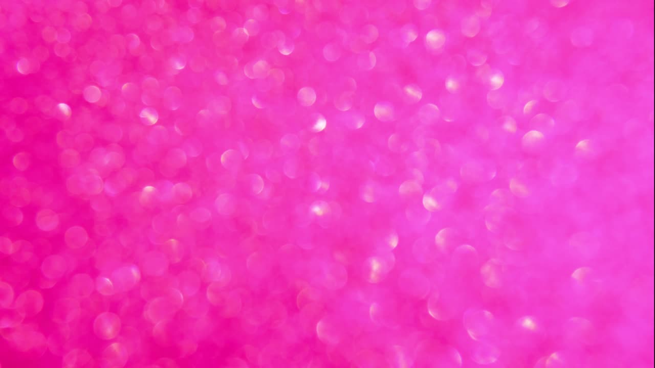 Decorative defocused abstract pink and gold background with sparkling glitter. Festive and holiday background for text. 4k footage
