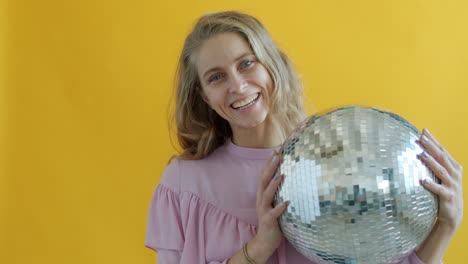 woman holding a disco ball