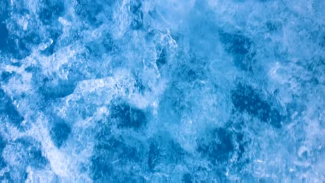 hectic, chaotic whitewash ocean wake and spray from a fast moving motorboat, closeup of sea and fast flowing swirling water