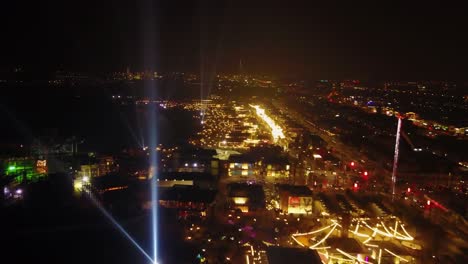 aerial view of a city at night with illuminated buildings and streets