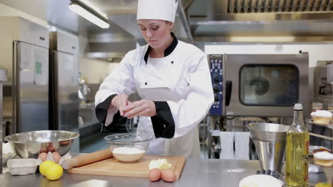 cook standing in the kitchen and preparing dough