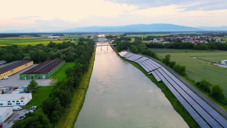 Captivating-aerial-4K-drone-footage-of-a-solar-panel-plant-nestled-alongside-the-Drava-river-in-Slovenia