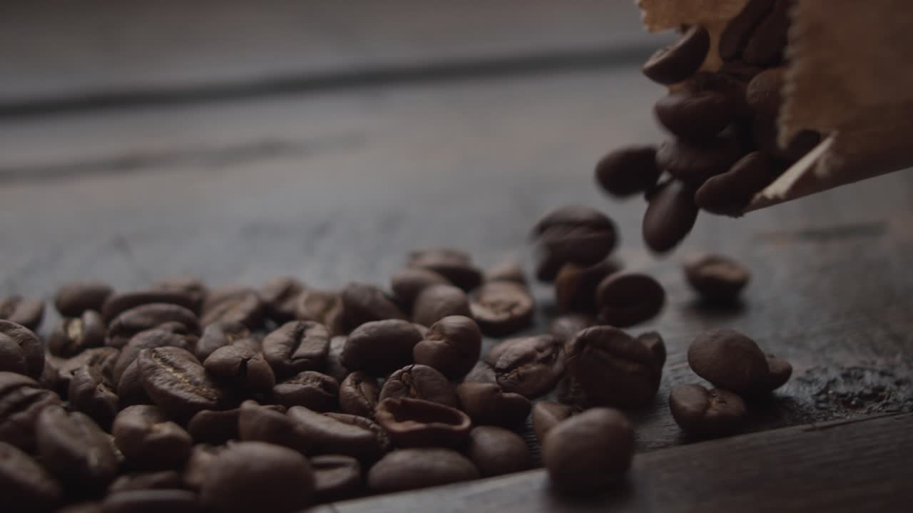 Spilling Coffee Beans from Paper Bag on Wooden Table