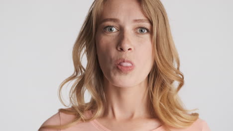 caucasian woman blowing bubblegum on camera.