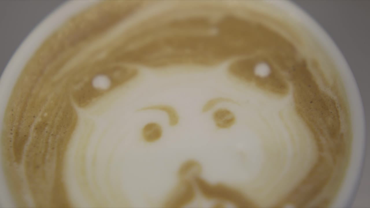 una cara es creada en la parte superior de una taza de café