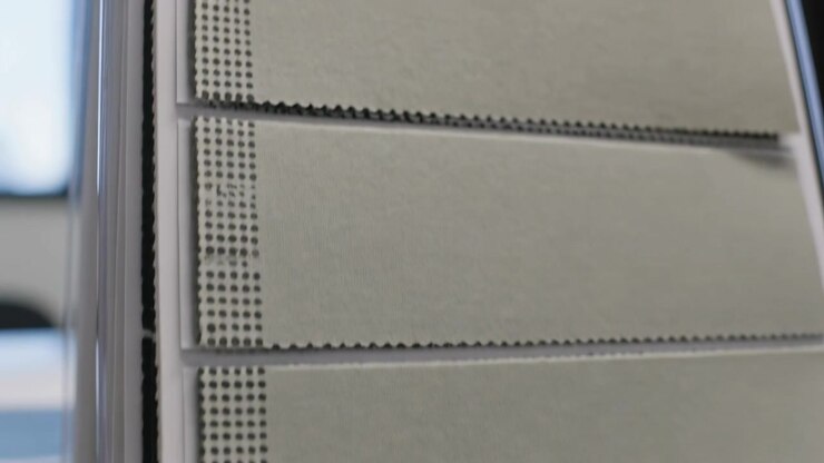 Moving camera showing swatch cards in acrylic stand on desk, printed label, focusing on dotted edge