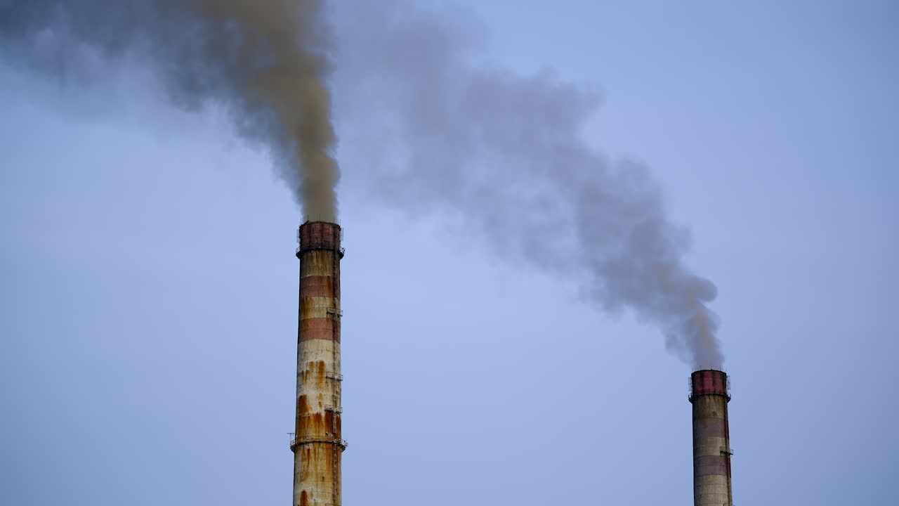 Smoking pipes of power plant. Toxic smoke coming out of factory chimney