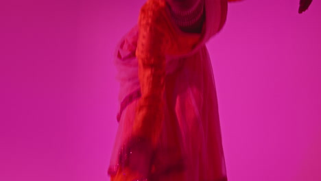 Studio-Shot-Of-Female-Kathak-Dancer-Performing-Dance-Wearing-Traditional-Indian-Dress-Against-Purple-Background-1