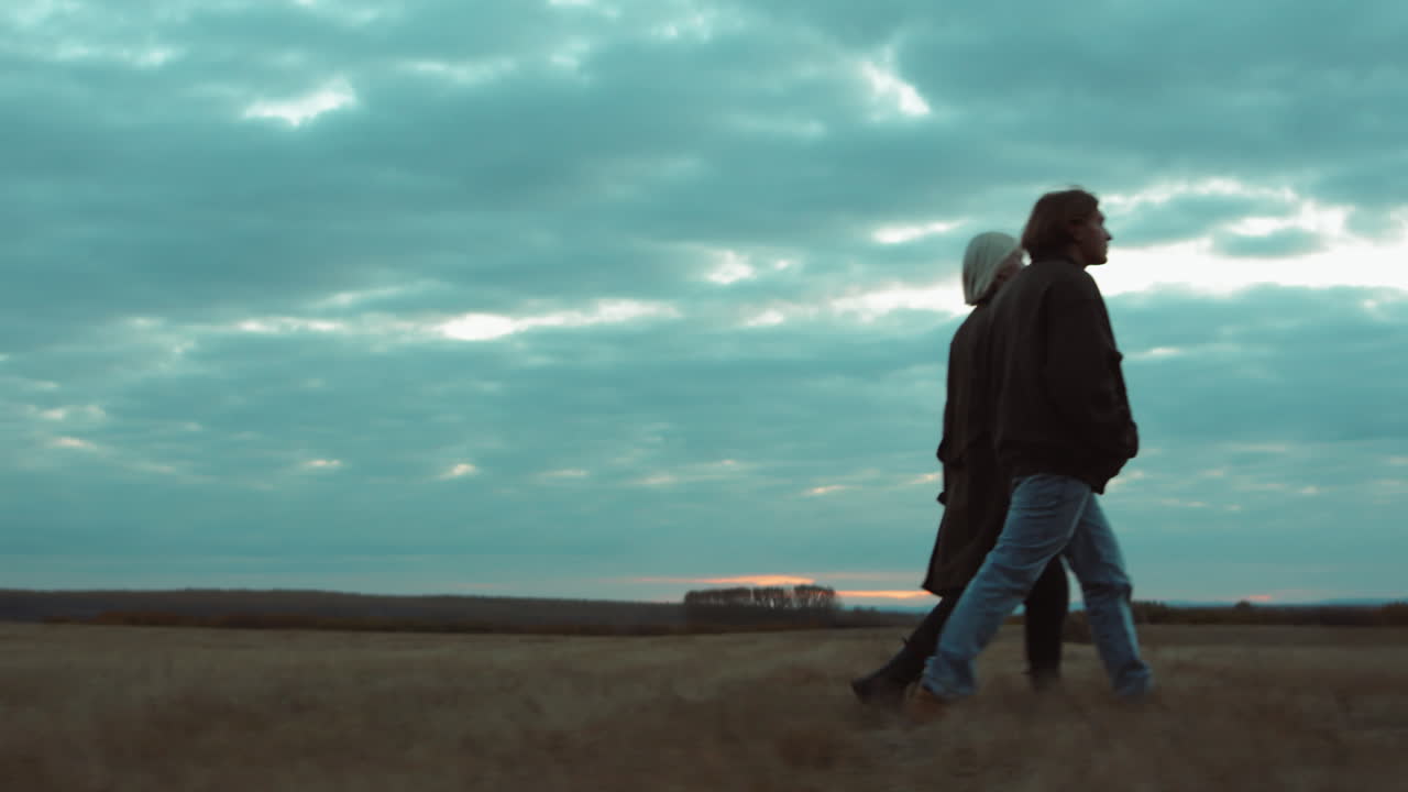 pareja caminando por el campo de otoño